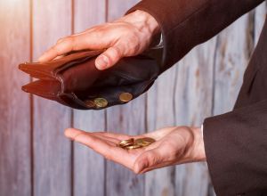 Hands holding coins and wallet.