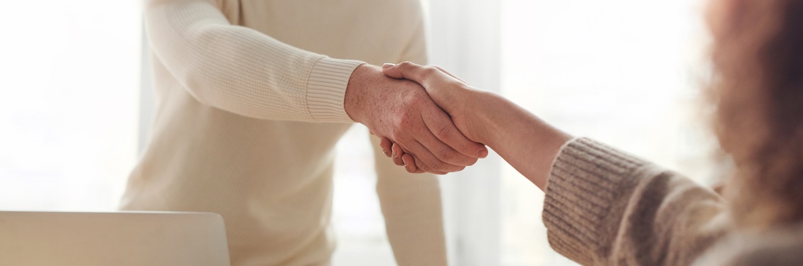 Ein Mann und ein Frau schütteln sich die Hände.